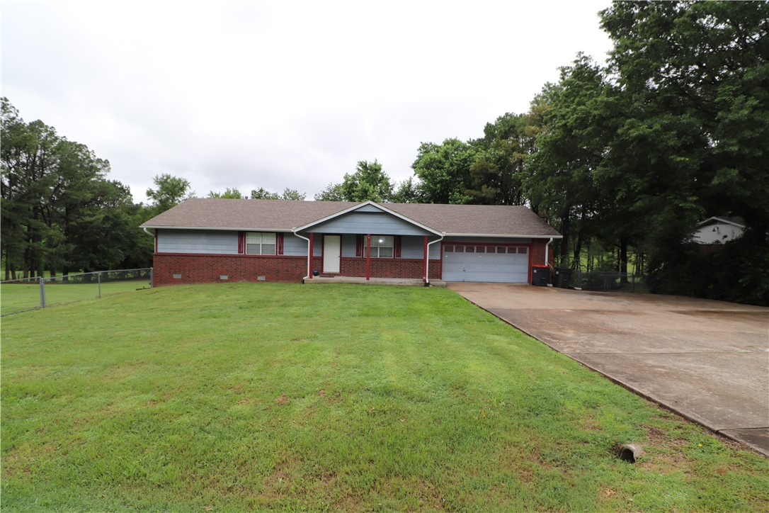 2,064+\- SQ Ft 3 bed 2 bath on a large .90+/- acre lot! This home is in an awesome location just off HWY 112/HWY 612 for convenient access to all of NW Arkansas. The interior features luxury vinyl plank flooring throughout, eat in kitchen, oversized bedrooms and bathrooms, and two living rooms. Outside you'll find a huge deck with patio underneath and a gorgeous backyard with lots of privacy. There is also an oversized garage with storage room and lots of concrete parking in front. Sold as is