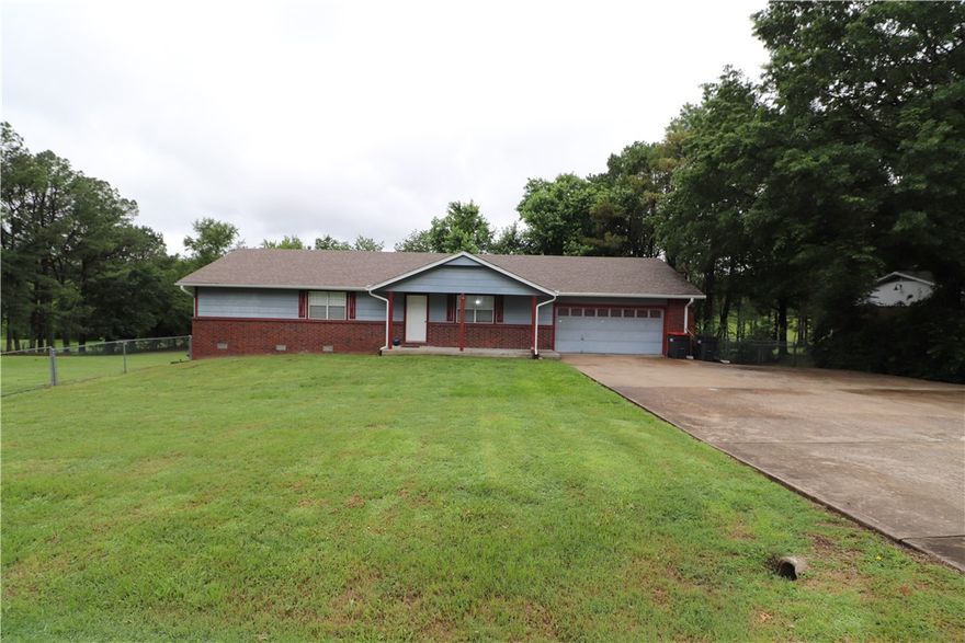 2,064+\- SQ Ft 3 bed 2 bath on a large .90+/- acre lot! This home is in an awesome location just off HWY 112/HWY 612 for convenient access to all of NW Arkansas. The interior features luxury vinyl plank flooring throughout, eat in kitchen, oversized bedrooms and bathrooms, and two living rooms. Outside you'll find a huge deck with patio underneath and a gorgeous backyard with lots of privacy. There is also an oversized garage with storage room and lots of concrete parking in front. Sold as is