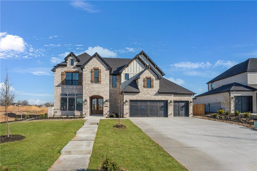 The Monroe is a two-story estate plan filled with natural light. The home features double front doors leading into a welcoming living room with direct access to the outdoor patio. The open layout includes a kitchen with a large island that offers additional seating, a breakfast nook, and a walk-in pantry. The owner’s suite is located at the back of the home with a walk-in closet and a bathroom that includes a freestanding tub. Also on the first floor are a secondary bedroom and full bath, along with a three-car garage connected to the utility room. Upstairs, you’ll find a media room, three bedrooms, and two additional bathrooms, along with a catwalk overlooking the two-story foyer.