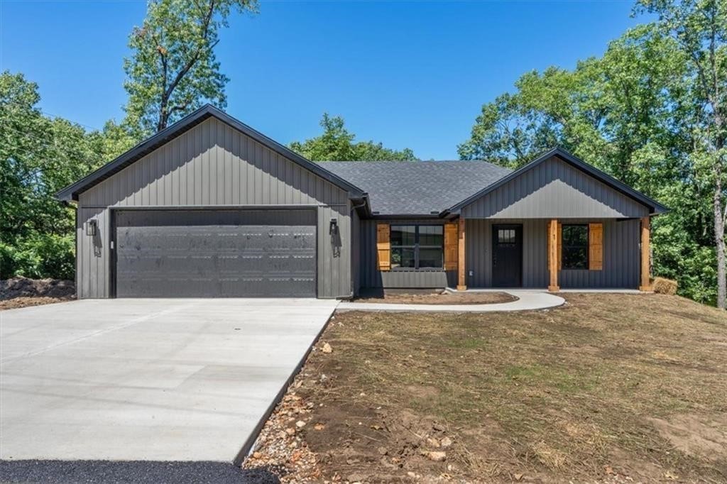 New construction in a fabulous location approximately 1.5 miles to golf at the Highlands Golf Course or boat ramp access at Tiree Park at Loch Lomond Lake! Heading to Bentonville and points south? 1.5 miles to bypass access! Great exterior colors with cedar accents. Split bedroom plan with three bedrooms and two baths. Primary bedroom with walk in closet and double vanity with quartz counters and fully tiled walk in shower in primary bath. Living room with gas log fireplace that separates the dining area. The kitchen has a designer feel--island, stainless vent hood, stainless appliances, quartz countertops and a great pantry. Fun covered porch off the dining area to enjoy your morning coffee. This is a really lovely, thoughtfully designed home at a great price! Ready approximately the end of September! Home for the holidays! **Under construction. Photos of previous build.** Completion date end of September/Mid October.
