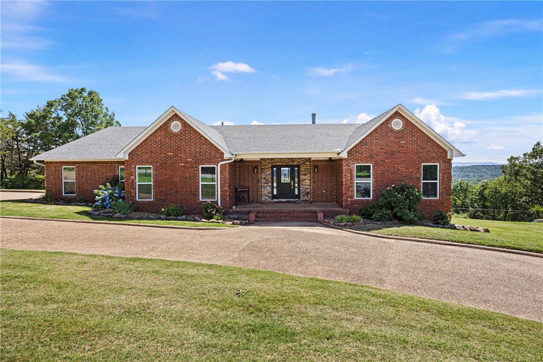 Perched on 1.5 acres at 3268 Crow Mountain Road, this 4-bedroom, 2.5-bathroom home offers breathtaking panoramic views of Mount Nebo, Petit Jean, Magazine, and Russellville. With approximately 3,238 square feet of living space, this well-updated home is designed to take in the scenery from nearly every room. The kitchen has been tastefully modernized, and the fully fenced property provides both privacy and space.A standout feature is the 32x45 steel shop, with 12-foot sidewalls, two motorized 10x10 insulated doors, loft storage, and a 16x16 covered patio. Currently set up for mechanics and woodworking, it includes LED lighting, water, and power. The woodworking area is double insulated with vinyl windows, making it perfect for any hobbyist. A rare find with endless possibilities.