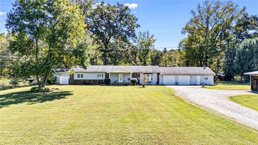 Discover country living at its best with this charming 3-bedroom, 2-bath home located on Broomfield Rd just outside of Dover. The main living room features a stunning rock fireplace built from stones found right on the property, adding a touch of character. A second living area opens to a bright sunroom, perfect for relaxing or entertaining. The kitchen offers ample space with a pantry, double oven, and electric cooktop, while the dining area provides a welcoming spot for family meals. Outside, you’ll find a 2-car garage with an attached workshop, a metal detached carport, and an additional workshop for all your projects or storage needs. The property also includes a storm shelter, a creek with a bridge leading to wooded acreage, and an old barn—offering endless potential for outdoor enjoyment.