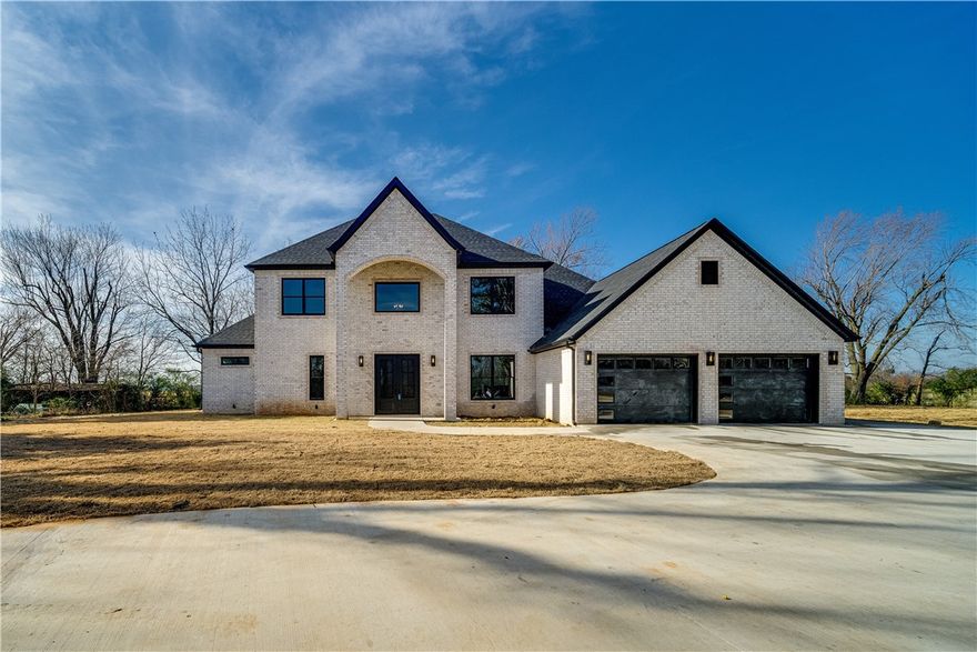 Experience this beautiful custom home minutes from downtown Bentonville. This architecturally Modern home with Grand Entry and floating stairway is nestled in a quiet neighborhood on 1.2 acres. This home offers open airy great room with waterfall Quartz kitchen counter tops. Enjoy the convenience of a main level Master suite with a big, beautiful master closet with island and built-in drawers. Another guest Master can be found on the main level with a walk-in closet and full bath. The second level features a spacious home theatre room. Home features contemporary sliding doors in Great room looking out to the porch with a built in grill. Do not miss this opportunity to possess this unique custom built home!