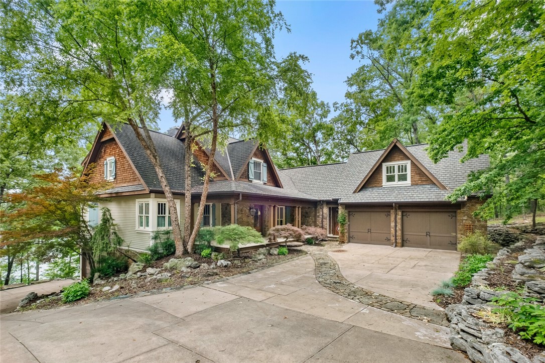 Straight out of a storybook & craftmanship of a true custom build, this one-of-a-kind lakefront retreat sits on 2.56 private, wooded acres near Starkey Marina. Thoughtfully designed & meticulously maintained, home offers 5,064 SF on 2 levels w/richly detailed living space w/1,965 SF partially finished basementāall filled w/high-end finishes. Inlaid wood floors, stained/leaded glass, custom cabinetry, iron railings, & built-ins, every inch reflects exceptional quality & care. The chefās kitchen w/Viking appliances, Sub Zero fridge, 2 sinks & dishwashers perfect for entertaining or everyday elegance. 3 En-suite bedrooms (1 w/loft), screened-in porch overlooking lake, & upper-level bonus room w/kitchenette, game & office space. The lower level includes a cozy living room w/wood-burning stove, full bath, & plumbed for future kitchen. Also includes 3-car garage, outdoor shower & gentle slope to the water. Rare bonus includes adjoining lakefront lot offering more privacy/future potential. Lakeside living at its finest.