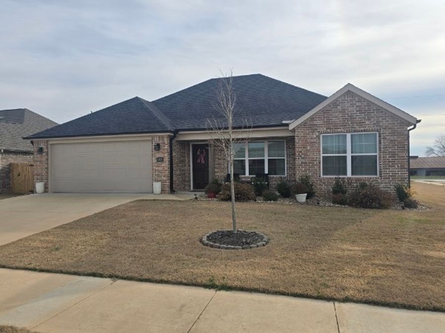 Close to I-49 but tucked away in a quiet neighborhood, this property offers the perfect blend of accessibility, affordability, and spacious rooms to make your life easy to manage. When entering the front, you will feel the bright, open, and inviting layout featuring newer LVP flooring that spans across to the kitchen. There you will see a nice island, granite counters, and stainless appliances. The cabinets have custom appeal, a convenient mud room at the garage entry, tray ceilings, crown molding, and high end finishes you would expect from a 2-year-old home. Out front, the landscaping offers curb appeal, set in front of a cute porch sitting area. This corner lot only has neighbors on one side! You’ll have a generous covered back patio space, and great level back yard. The community pool is a short walk down the street, which is accompanied by a massive, covered pavilion and playground. Get all this in a fantastic area with resort style amenities and great access to all things NW Arkansas! Open House Sunday 2-4pm!