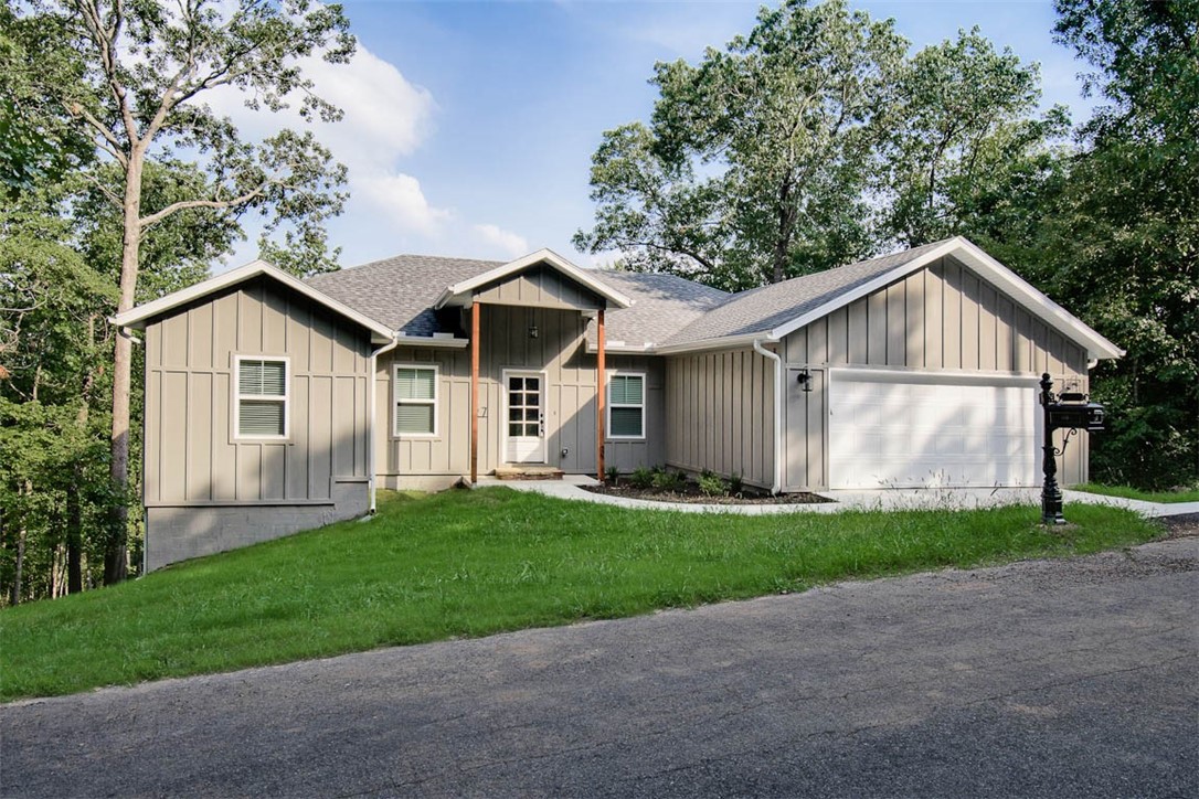 Elegant one story newer construction home that is private and beautiful with a gently sloped back yard large deck and wonderful wooded views. Spacious 3 bed 2 bath split floor-plan with many custom touches including granite counters, custom owners en-suite full bathroom with tiled shower and soaking tub, floating electric fireplace, beautiful LVP in main areas, open kitchen, dining and great room perfect for entertaining. Unexpectedly large laundry/mud room to provide loads of storage and functionality! Location is ideal in Bella Vista with golf, tennis, lakes, trails, parks, community/exercise facilities and several restaurants. In Bentonville School district and close to all that NWA has to offer.