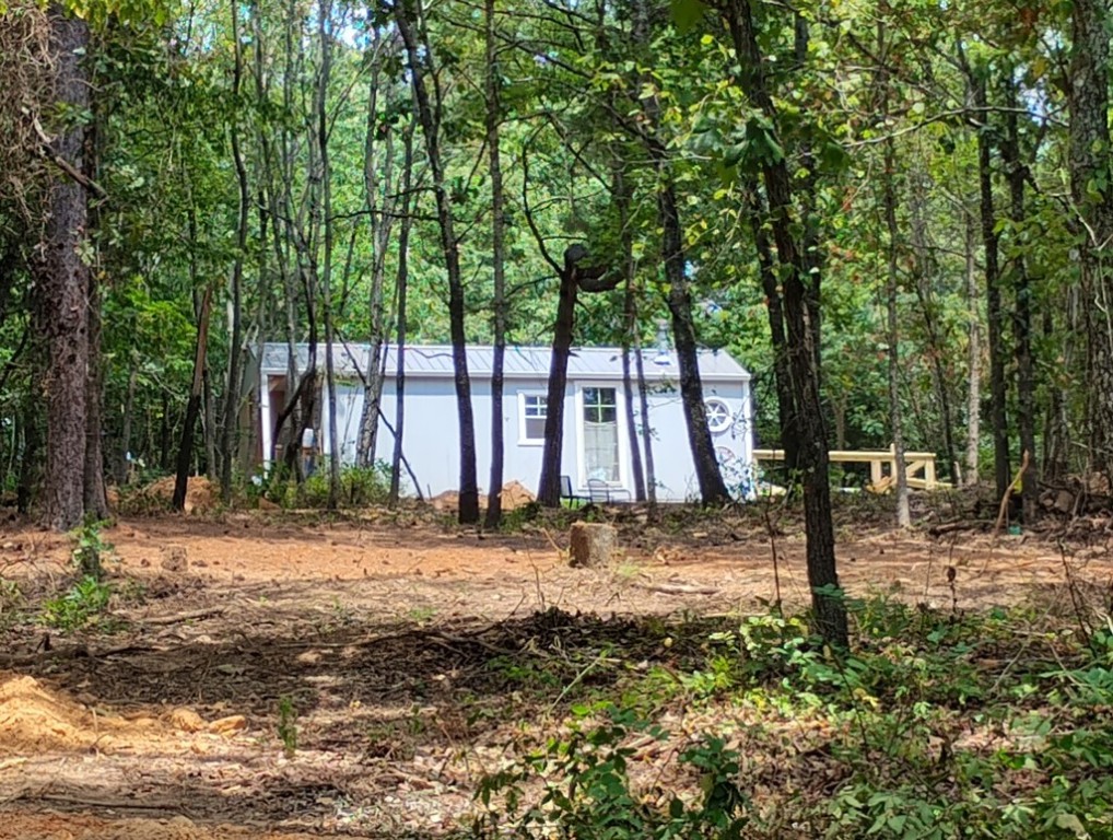 Discover the enchanting town of Winslow, where a delightful tiny home awaits. Enjoy how it is nestled among beautiful, majestic trees on a perfectly sized lot of almost 2.5 acres. Perfectly situated between two historic churches, this tiny home is an absolute gem.
