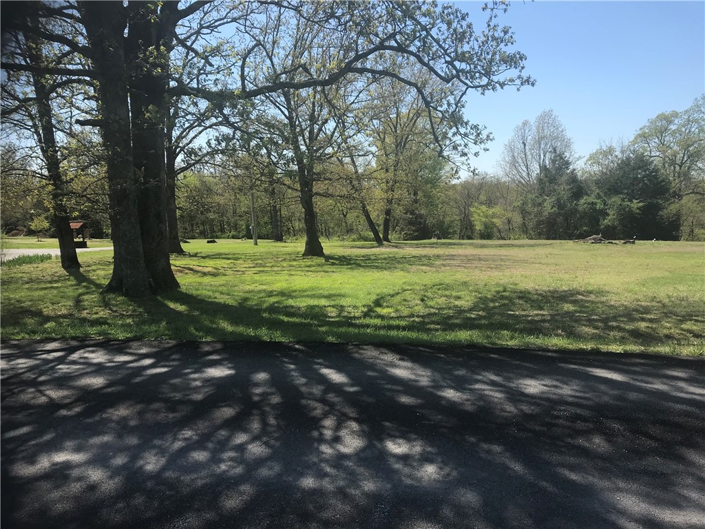 Exceptional 5 acres in scenic Garfield! Live in the country, but only 15 minutes from Rogers. The 5 acres is comprised of 2 parcels being sold together. 1.74 level cleared acres fronts Ravenwood Ln, a lovely paved residential road. The adjacent parcel is 3.3 acres of gently sloped natural forest/wooded. Land is located only 7 minutes from nearest Beaver Lake boat ramp. Electric and Public Water at the street. Land has been perked for septic system.