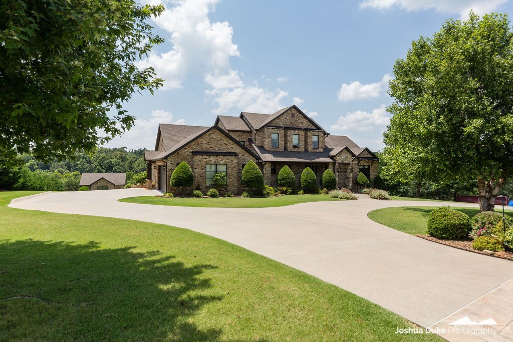 Impeccable craftmanship and custom built! Home features hand scraped hardwood floors, custom beams from the "Blue Ridge Mountains". 8' doors and 10' ceilings. Open kitchen to vaulted Great Room with veranda views. Super floor plan with Master Suite and gorgeous Master Bath. Master and Guest room with private bath both on main level. Two bedrooms with jack and jill bath and bonus on second level. Immaculate garages! 2 car attached and a 25x21 detached 2 car garage. Everything is in perfect condition. All on a private 2 acre setting.