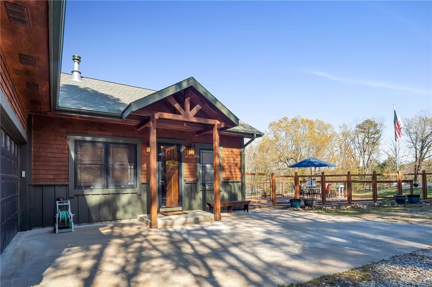 Custom and carefully built home with views of Beaver Lake from nearly every room. This home is perfect for entertaining guests with the large open concept living room, large eat in kitchen and sliding door that leads out to the deck with sweeping views of the lake. Each bedroom downstairs has doors that lead out to the patio. Retreat to the Primary bedroom with en suite bath and walk in closet. The attached garage is drive through and the detached garage adds room for extra storage. Stroll down to the lake and enjoy 66 feet of lake front and your own private 1 slip dock with swim platform. Home constructed with Anderson EE doors and windows, lower level 8" thick rebar reinforced concrete walls, 12" thick ceiling insulation and more.