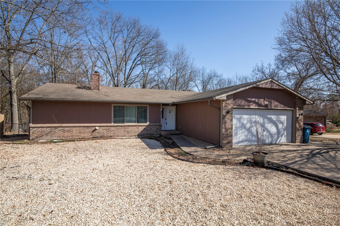 Adventure awaits! New paint and new carpet! This home boasts a fantastic layout and picturesque backyard views, all while being perfectly situated for the outdoor enthusiast. Imagine being minutes from world-class mountain biking trails, a short drive to the shimmering waters of Lake Avalon and Lake Windsor, and just a 3-minute hop to the enchanting Tanyard Creek Nature Trail. Enjoy the convenience of being near the town center, while still having nature's playground at your doorstep. This is more than just a home; it's a gateway to the active Northwest Arkansas lifestyle you've been dreaming of. New upgraded water heater with recirculating pump as well as newer windows.