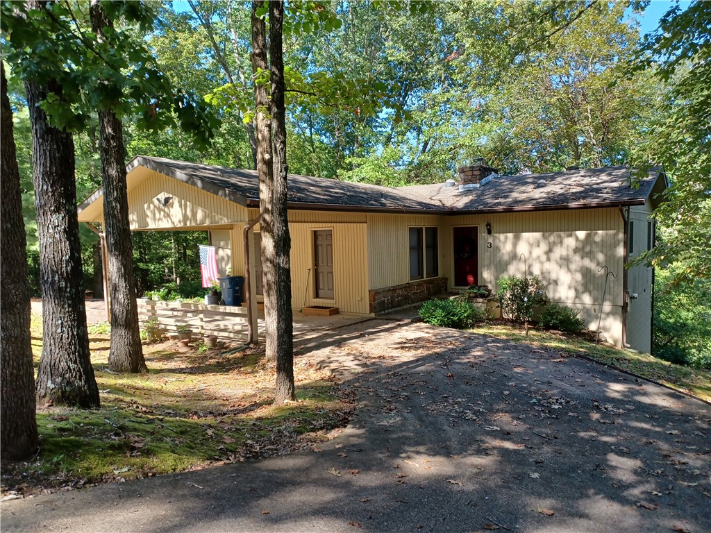 Light and Bright! Many large windows and even some solar tubes. Kitchen has great cabinet and drawer space and a pantry to boot! Master is large with 2 closets and door to the deck. The second and third bedrooms also have doors to the deck. Spacious living room has door to deck and a wall of windows overlooking scenic Bella Vista trees and wildlife. Basement room has concrete floor and is ideal for extra storage. This sweet house has been loved for years by its one and only owner. Time has come to downsize and move closer to the kids. Take a look at the enormous charm and warmth of this home.