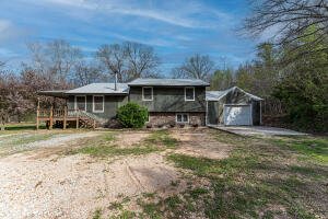 Sweet 2 bed, 2 bath home on 2 acres m/l. Nestled in the trees, this home has several renovations that make it extraordinary. Wrap around deck with privacy. Appliances convey with home. Bay windows reach from floor to ceiling in dining area. Granite counter tops in Master Bath along with walk in tile shower and heated tile floors outside of shower. Tiled basement floor. Hardwood floor on Main level.