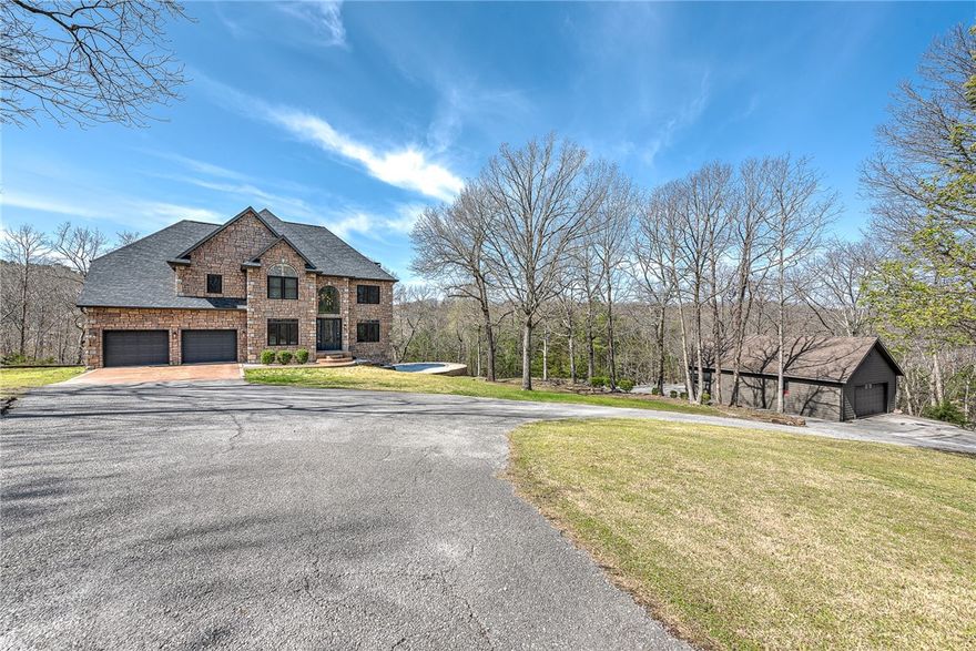 With its modern amenities, expansive outdoor spaces and unbeatable location, this "Stone Haven" at 8361 Forest Hills Lane is more than just a property; it’s a lifestyle. Fully renovated in 2021 and meticulously maintained, this turnkey home is situated in a gated estate community - offering privacy and peacefulness. This stunning home features an open-concept design with matte black fixtures, porcelain tile, Carrara marble, arched windows, and smart home technology for modern convenience. A versatile lower level provides direct access to the pool and includes a wine cellar, as well as multiple flex spaces - perfect for home gym, office or more. Outside, enjoy the peace and relaxation of a covered patio and inground pool with a new retaining wall for expanded sun deck. The detached, drive-through garage for boats, cars, or bikes provides the perfect storage space for hobby enthusiasts. This exceptional home sits just 1 mile from the HWY 12 boat ramp, 3 miles to Prairie Creek Marina and 5 miles to Downtown Rogers.