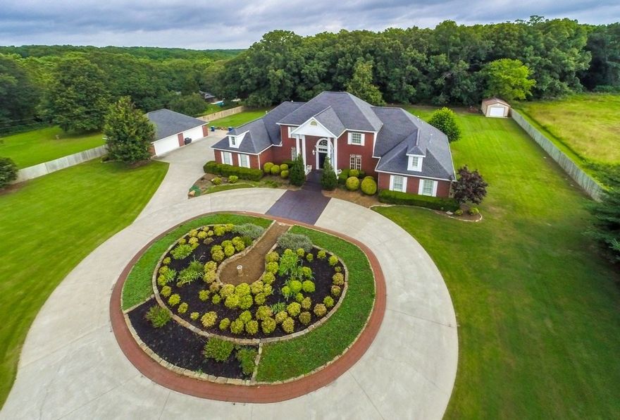 Nearly 6 acres with stately plantation - like home with beautiful pool. Also included on the 5.58 acres is a 1408 SF finished out w/heat  and air office building/garage/shop and a cute guest house. So many possibilities!!!
