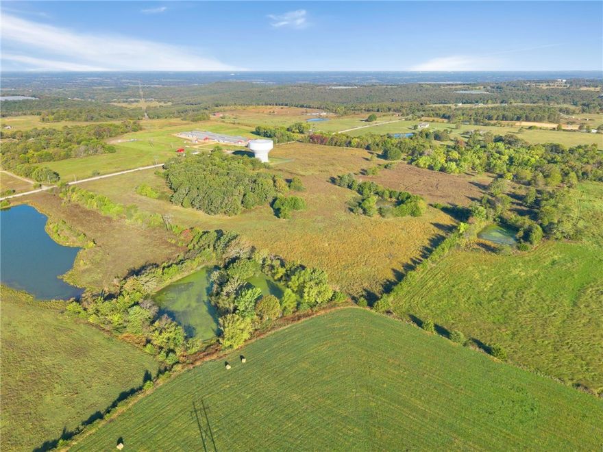 12.03 AC Homestead - Just N of Lincoln Lake, along Jackson Hwy, this 12.03 AC also has access along Hunton Ln. This is a great location for building your dream home or a secluded getaway. Enjoy the scenic ridgetop w/breathtaking views while utilizing the established pasture/hay ground for livestock. The property includes a 1008 SF-1914 farmhouse with 2BR/1BA, full of character & good bones, ready for restoration or a weekend retreat. Several outbuildings add to the charm & functionality, including a historic log smokehouse & several barns, perfect for those who appreciate heritage & craftsmanship. Shaded by century-old oak trees & mature hardwoods, the property offers peaceful seclusion w/the added bonus of being within minutes of town. Enjoy privacy & convenience, just 10 minutes to Lincoln schools, shopping, gas & dining, 20 minutes to Siloam Springs or historic Prairie Grove & only 30 minutes to the U of A. More land is available for purchase if desired. Also See MLS# 1326116, 1326221, 1326228, 1326244, 1326252