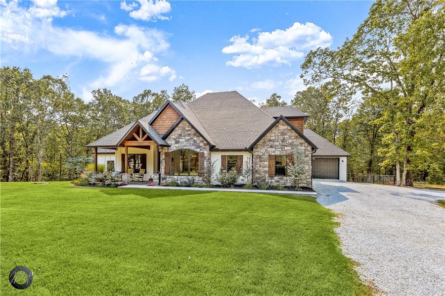 Beautiful custom home in West Fayetteville on approximately 11.5 wooded acres. Located about 10 minutes from I-49. Home features a covered front porch with a porch swing to relax and enjoy the views. The large covered back porch is great for entertaining with a sink, grilling area, and stone fireplace. The home has 4 bedrooms, 3.5 baths, and a 3 car garage. The master bath features a large shower with 2 shower heads, jacuzzi tub, and walk-in closet. Upstairs you'll find a large bonus room that could be used as guest room or playroom, a full bath, and a large walk-in closet. The home has granite countertops, instant hot water, black stainless electric appliances, and new carpet. You'll have tons of storage in walk-in closets, butler's pantry, and attic. Outside you'll find a fenced backyard, pond, and chicken coop. There is a covered area for parking RVs and a new 1,440 sf shop with 3 large bay doors. Also, a dog wash area in the 3rd car garage. You don't want to miss this one! Agent owned.