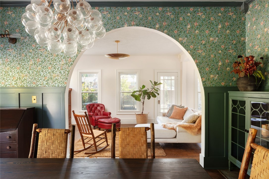 Built around 1930 and featured in At-Home In Arkansas magazine, this century-old rock farmhouse has been lovingly maintained and renovated. Seamlessly combining the rich colors and designs of British Maximalism with the classic elements of Old-World European farmhouses, this Bentonville landmark elevates the historical to the artful. Elements of the redesign, directed by Meet West Studio, include William Morris and House of Hackney reproduction wallpapers, custom penny tile by American Restoration Tile, and complete redesigns of the kitchen, baths, laundry, and mudroom. Kitchen features high-end appliances like the Ilve Nostalgic Series gas range and Fisher and Pykel built-in dishwasher and refrigerator. The grounds continue to charm with a matching stone ceramics studio, the old dinner bell, perennial and native landscaping, potager garden, and a stone fire pit. A master gardening plan for future enhancement will convey. New roof (2019), HVAC (2020), water heater (2023), and garage and studio gutters (2023).
