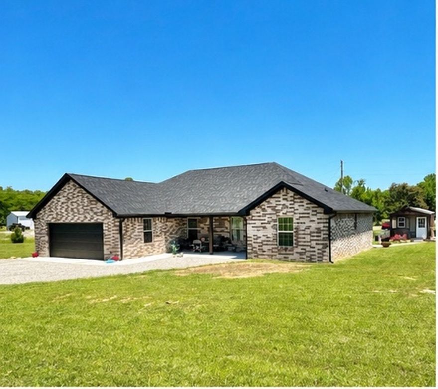 This stunning home blends modern style, thoughtful design, and everyday comfort on approximately 0.99 +/- acres in The Meadows Subdivision. Built in 2024, this beautifully crafted 3-bedroom, 2-bath home offers 1,700 sq. ft. of stylish living space with upscale finishes throughout.

The open-concept layout features quartz countertops, a spacious kitchen island, stainless appliances including refrigerator, dishwasher, microwave, and range, plus abundant LED recessed lighting. Custom built-in shelving and storage add charm and functionality throughout.

The primary suite offers a large walk-in closet and walk-in shower. Enjoy the electric fireplace or relax on the covered rear deck overlooking the spacious lot.

Additional features include a 2-car garage, partially floored and lighted attic, 30-year architectural shingle roof, and an insulated workshop with electric. Modern comfort and quality craftsmanship throughout!