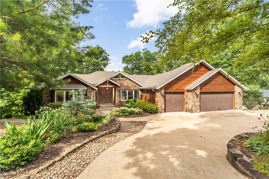 Welcome to the lake life on Bella Vista's Loch Lomond! Located just down the cove from Lakepoint Marina and Restaurant, this 4 bedroom, 4 bathroom home on sewer is a dream come true. Everything has been remodeled, updated and finished with the luxury you want and expect. All 4 bathrooms have been outfitted with walk-in tiled showers. The Kitchen has also been updated and features an island with a propane cooktop. A covered boat dock and slip has been added, along with a stone fire pit area. There are not one, but two Master suites on the main floor, and an office and screened porch. The finished, walk-out lower level features two more bedrooms and a full bath. The lower level has plenty of storage...AND a heated and cooled workshop!! Plus there's a wet bar in the lower level. The square footage does not count an additional 851 square feet that is heated and cooled, bringing the total square footage to 4,732! If you have dogs, let them roam the property protected by an invisible fence. This home truly has it all!!