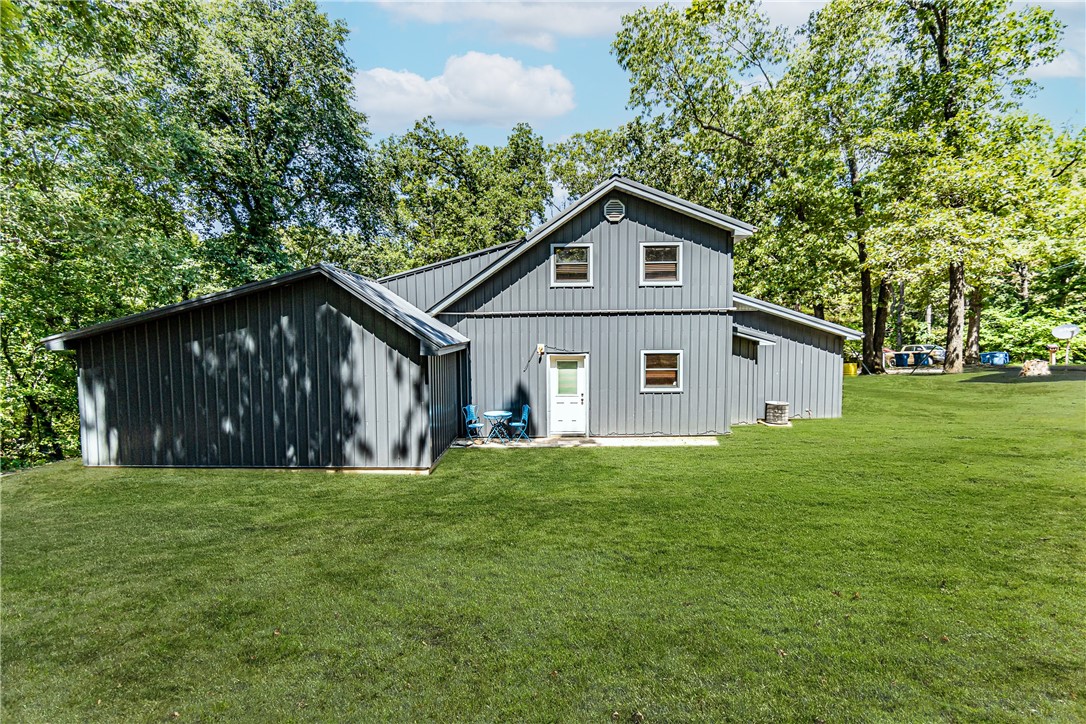 Recently remodeled Gravette home! This 4 bed, 2 bath home sits on a secluded, tree surrounded lot on a quiet cul de sac. Interior amenities include two bedrooms and one bathroom on both the lower and upper levels, tall vaulted ceilings in the living and dining area creating a spacious and airy feel, and a stunning wood burning stone fireplace in the living area. The renovated kitchen showcases white cabinets, stainless steel appliances, and plenty of storage space. Enjoy evenings from your large screened porch. Upgrades include all new flooring in the main living area, new countertops in the kitchen, metal roof installed in 2022, 50 gallons hot water heater in 2021, and more! Utilize the 283 sq ft outbuilding to store all of your tools and equipment. Don’t miss out on this opportunity today!