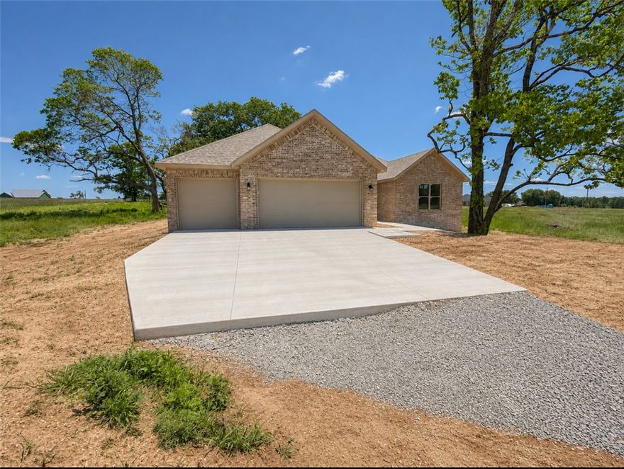 New construction home situated on 3.6 +/- acres offering 4 bedrooms, 3.5 bathrooms, and a functional open floor plan. Features include a spacious living area, large kitchen with ample cabinet and counter space, split-bedroom layout, and a primary suite with walk-in closet and private bath. One additional bedroom includes a full en suite bathroom, making it ideal for guests or multi-generational living. The property offers mature trees, open space, and room for outdoor enjoyment, gardening, or future improvements. Enjoy the privacy and peaceful setting while still being conveniently located to nearby amenities, schools, and highways.