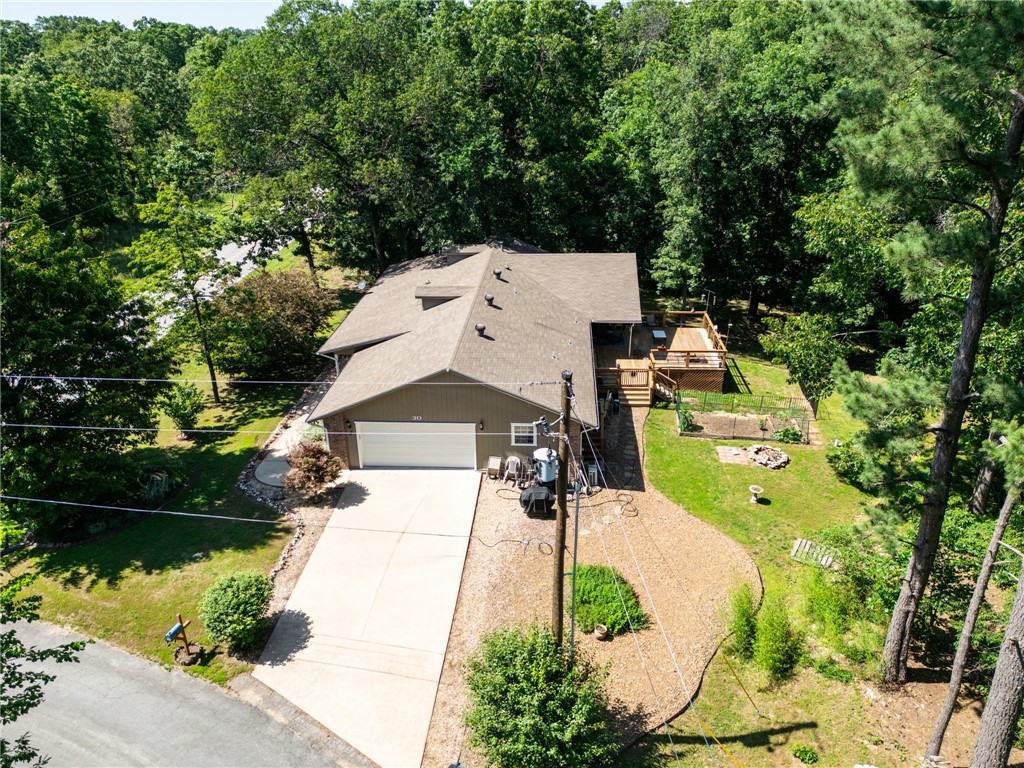 Discover your private retreat with this custom ranch home on 1.6 acres, just minutes from Lake Loch Lomond. Nestled in a serene, tucked-away spot, it offers space and tranquility. Inside, vaulted ceilings and bamboo floors create an open, inviting feel. The split floor plan features a luxurious primary suite with a walk-in shower and a second well-appointed bath. Relax on the expansive deck, enjoying wooded views across TWO additional lots. The oversized garage includes a heated and cooled workshop or office, perfect for hobbies or work. For added flexibility, the sellers offer a lower price if purchased with just two parcels. This rare blend of modern elegance, acreage, and lake proximity won’t last long. Schedule your private tour today to customize your deal and claim this dream home!