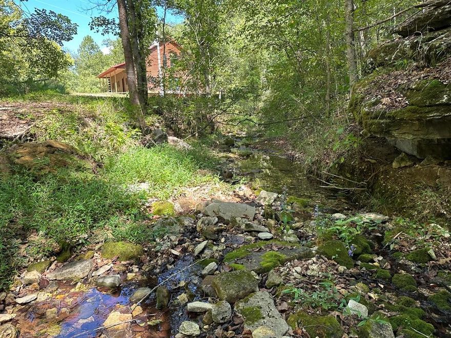 Nestled on 200 acres of pristine wilderness, this luxurious unfinished log lodge promises an escape from the hustle and bustle of city life. The lodge, a masterpiece in progress boasts 4 bedrooms, 3.5 bathrooms, cedar-lined walls, majestic vaulted ceilings, a huge staircase, a wrap-around deck, and a basement with concrete walls and floors. Adding to the property's enhancement is a 30 x 40 Pole barn. Tucked in the rolling hills of the heart of the Ozarks, sits a truly unique opportunity. For the avid hunter, this property is a paradise with abundant wildlife, caves bluffs, and creeks. Investment potential abounds with multiple road frontages, making this property a savvy choice for those seeking to capitalize on its prime location.