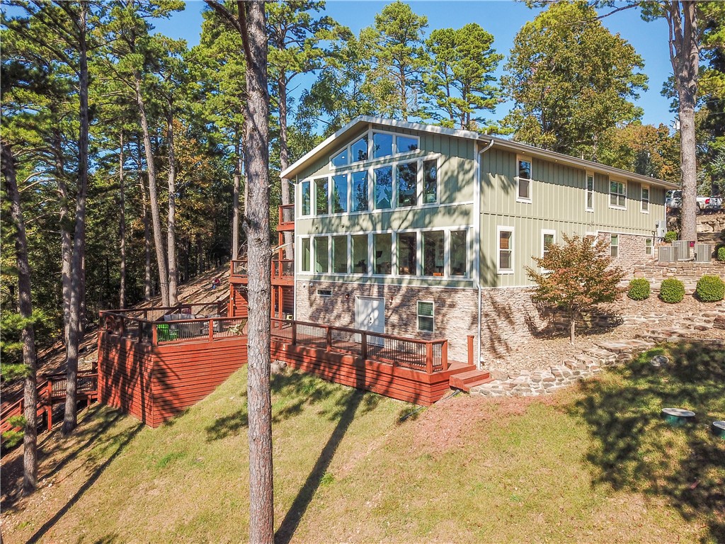 Luxury living on the Lake! This 4 bed, 5.5 bath home boasts lake views year round. The floor to ceiling windows on both levels of this beautiful home offers a gorgeous view of Beaver Lake 365 days a year! Two large master suites, two kitchens & two living areas for gathering family & friends. The chefās kitchen is perfect for entertaining. Choose from 3 patios for fabulous outdoor living, your morning coffee or evening cocktail. The outdoor kitchen adds yet another place to share an intimate gathering or host a celebration! On chilly nights you can stay warm by the fire pit that overlooks the lake.
Take the easy walk to the water, jump in your boat or take a relaxing swim from your 2 family community dock. When you are done enjoying the day, indulge with a shower and toss your towels and suits in the second laundry room located in the spacious heated/cooled basement.
This luxury home with breathtaking views and amenities throughout will offer precious opportunities for making memories with friends and family!