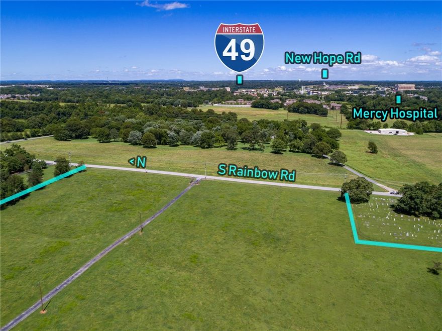 GREAT DEVELOPMENT POTENTIAL, 23.61 ROLLING ACRES WITH POND AND  620+/- OF ROAD FRONTAGE, MINUTES FROM I49, THE PROMENADE AND WALMART HOME OFFICE IF INTERESTED IN DEVELOPMENT PROPERTY IT WOULD BE HARD TO BEAT THIS LOCATION.