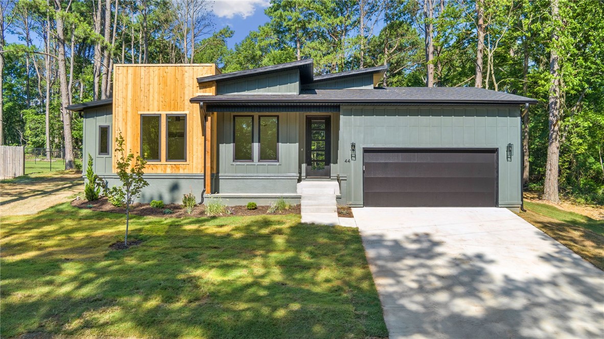 Welcome to your modern retreat in beautiful Bella Vista! Nestled on a flat, secluded lot, this stunning 2-bedroom home with office boasts full Hardi siding and a spacious covered back porch perfect for year-round enjoyment. Inside, you'll find rich hardwood floors throughout, a custom fireplace that anchors the living space, and eye-catching wooden accent beams on the ceiling. The kitchen is a true showpiece with a full custom backsplash and quality finishes throughout. A dedicated office and mud room offer added convenience and functionality. The owner's suite is a true escape, featuring a spa-like bath with a full tile shower, dual vanities, and a generous walk-in closet. Designed with both style and comfort in mind, this home blends thoughtful craftsmanship with serene outdoor living. Whether you're entertaining or relaxing in peace, you'll love everything this home has to offer. Don’t miss your chance to own this one-of-a-kind Bella Vista gem!