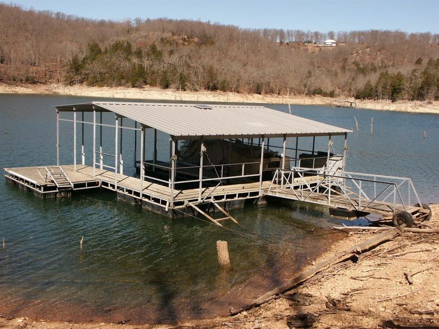 This lot is your ticket to a great view AND a private dock! Easy, level, paved road access to this three acre lot, makes the drive to your home site a joy. Build on top of the lot to enjoy the view and love the easy access drive down to the dock! The two slip dock includes a swim platform, boat lift, and solar power. Panorama Shores is a subdivision of nice homes and all lots are over 3 acres making this an excellent place to build your dream home!