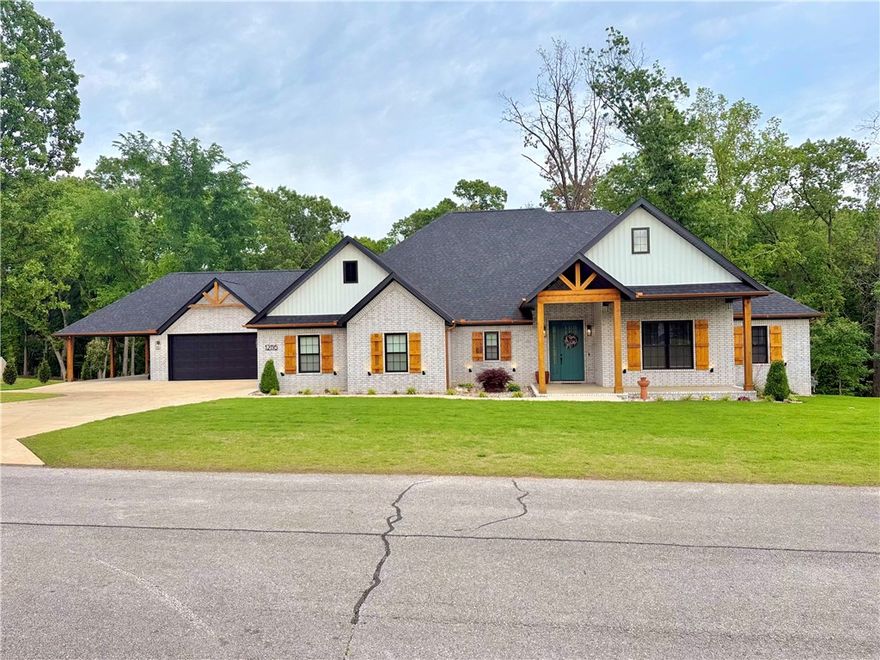 This 2782 sq ft, 4 bed, 3 full, two 1/2 baths home in Timber Ridge Estates offers privacy and convenience, minutes from Rogers and Pea Ridge. Set on a landscaped 1-acre lot with mature trees, it features a split floor plan, open-concept living spaces, wood flooring throughout except tile in baths and laundry. There are two master suites with walk-in closets, tiled showers, and makeup counters; the primary closet includes large island for storage. The kitchen flows into living and dining areas, with upgraded appliances, a linear fireplace set in linear rock wall, built-in china cabinet, and a walk-in pantry with fridge hookup. Enhanced insulation supports energy savings and sound control and home security system with cameras are installed extra peace of mind. Two oversized garages are available, one heated/cooled for flexible use. The  large covered back patio is perfect for outdoor living: entertaining or just relaxation. With thoughtful design and quality upgrades, this home stands out in today’s market.