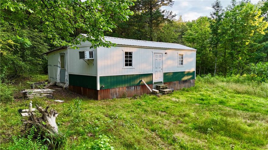 Tucked away in the peaceful countryside, this 1-acre lot offers privacy, potential, and a rustic start to your dream retreat. The main 16' x 40' structure includes a studded 12' x 12' addition—perfect for customizing into your ideal getaway. Electric and water are already on site. With a little vision and effort, this property is ready to be transformed. Sold as is—bring your imagination and make it your own!