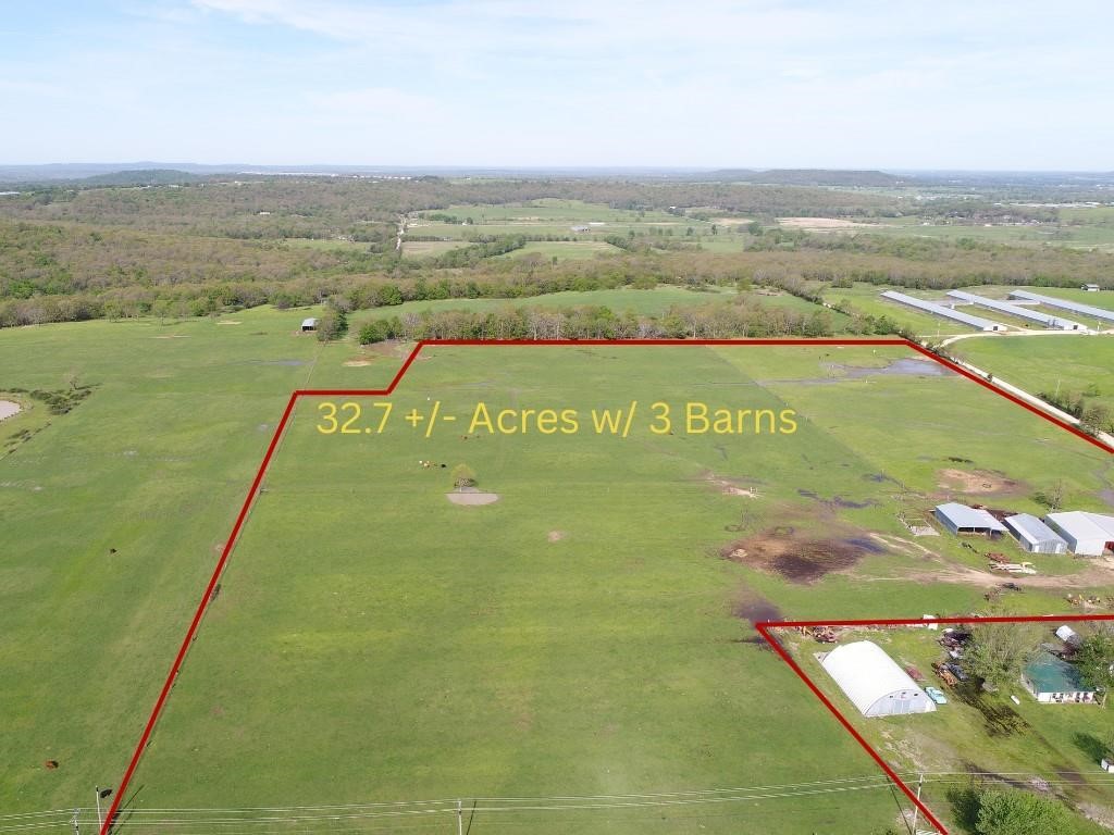 32.7 +/- acres of pristine fertilized and managed pasture ground with pond and three barns ready for purchase. Livestock Barn with corrals for working cattle, hay barn with office, equipment barn, and started pole barn ready to be completed with property. Paved road access on east side of parcel and gravel road to the north side. Water tap to be provided along with current survey. This pasture ground has been very well managed for the livestock farmer. Perfect place to build a home and have a nice farm ready to go with ships, barns, and corrals. Come see it soon, reasonably priced and ready to go.
