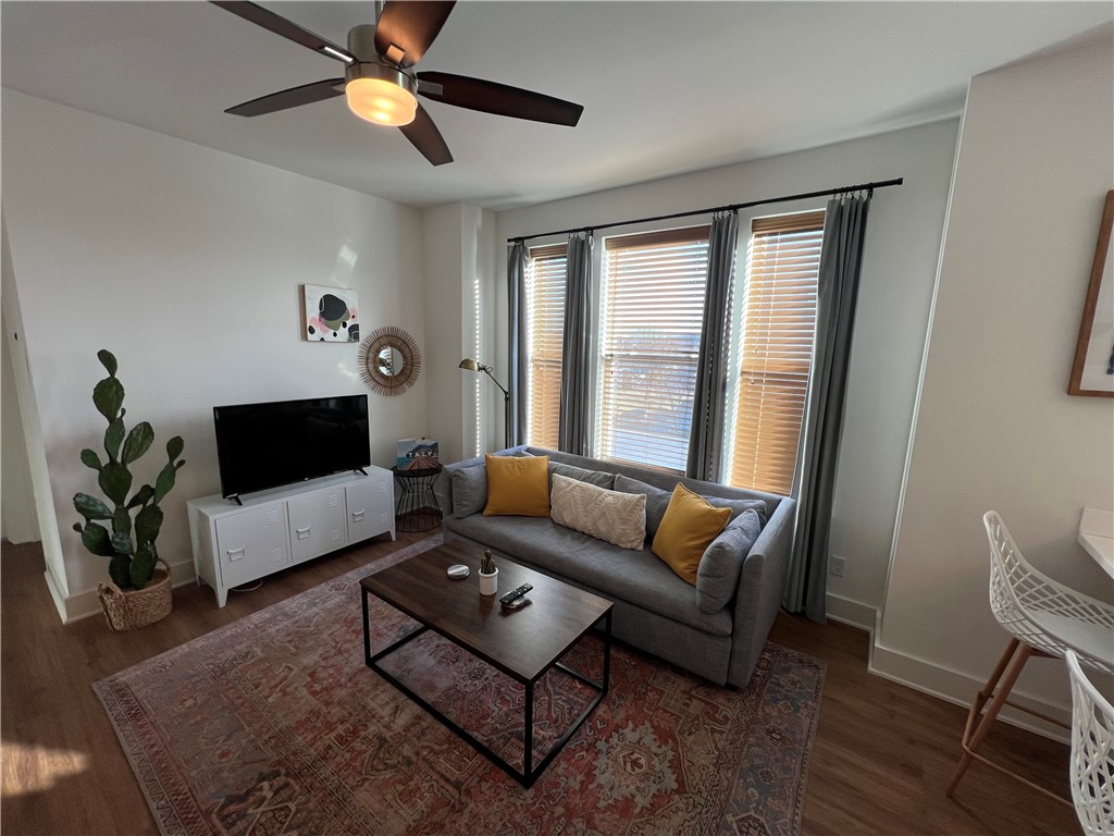 This modern 1-bedroom apartment features large windows that flood the space with natural light, creating a bright and airy atmosphere. The open floorplan and high ceilings enhance the sense of space and openness. The all-white kitchen is not only stylish but also contributes to the overall brightness of the apartment. It is equipped with solid surface counters and stainless steel appliances, providing a sleek and modern look. The bedroom is spacious and includes a cozy reading nook, offering a comfortable space to relax with a book or unwind after a long day. Additionally, the apartment offers controlled access at street level, providing an added layer of security and convenience.
