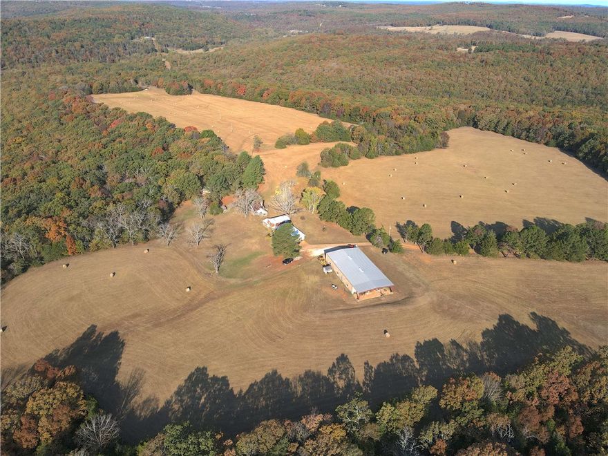This stunning 280+/- acre property is breathtaking from the moment you pull down the private
dead end road. With 2 homes, a 6000 sq foot shop and an incredible mix of marketable timber
and pasture, the possibilities are endless. As you pull on to the property, you will notice the
well maintained roads. Down one road you will find a beautifully secluded 2 bed 1 bath 1,530 sq ft log cabin in the woods with views through the trees to the open pasture on the other side. Down the other road will lead you through a tunnel of towering pine and oak trees to another 3,000 sq ft older home (both
homes sold as is) and a 100x60 insulated shop with concrete slab floor. Surrounding this area
you have views stretching 360 degrees of the rest of the acreage. With a
beautiful mix of pasture, hardwood timber, wet weather creek and 2 ponds, every turn you take
will surprise you. With no hunting pressure for over two decades, wildlife thrives here, making
it an ideal setting for a farm, private retreat, or recreational haven.