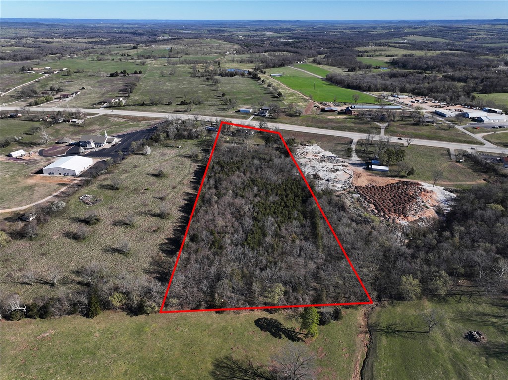 This fantastic 9.36 acre property sits just outside the city limits of Berryville, offering the perfect balance of convenience and opportunity. With highway frontage for excellent visibility and all utilities already in place you'll save both time & money when developing your dream business, home or combination of both! The land is ready for your vision. The mobile on the property is currently rented on a month to month basis, providing income.