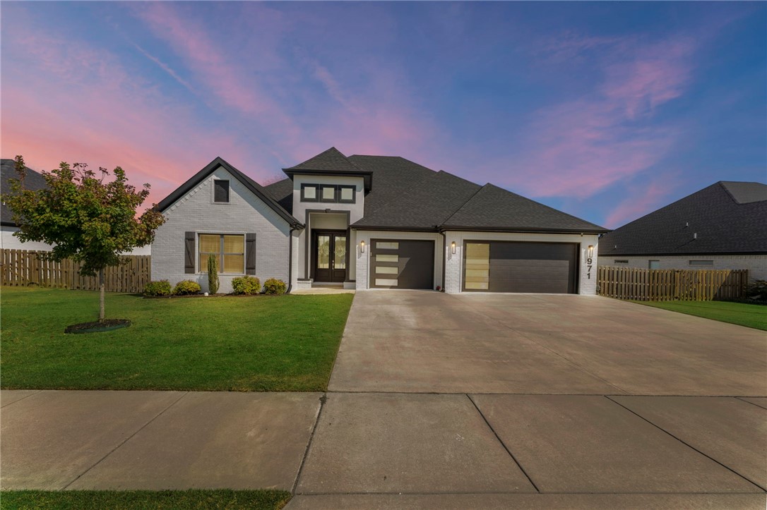 Discover versatile living in this spacious one-level home on a .40-acre lot in sought-after Osage Creek, just minutes from Walmart Home Office, top schools, and scenic trails. With 4 bedrooms, 3 baths, and two living rooms, it’s ideal for multigenerational living, in-laws, or private en suite quarters. The chef’s kitchen boasts a gas stove, oversized island, upgraded granite, and custom cabinetry—perfect for entertaining. Retreat to the primary suite with patio access, soaking tub, and walk-in closets. Every bath features quartz counters, blending style and function. The second living room also opens to the back patio, where a cozy fireplace creates an inviting outdoor retreat. A rare find combining flexibility, luxury, and location.