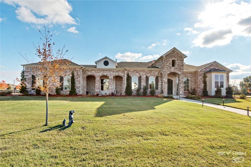 Over 1 acre on this lovely estate with custom open floor plan; high ceilings, gourmet kitchen-GE Cafe appl; seamless 10 x 16' doors bring outside in! Luxurious private owner suite upgraded with his/her contemporary waterfall shower panel in Master, soaking tub; remote control blinds, garage doors upgraded; entry iron dbl door w/screens operable windows. New carpet in bedrms, new paint. Solar panels run home.