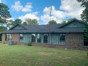 Charming ranch style home on 5.29 wooded acres in Russellville. 2,136 sqft home with 2 beds, 3 baths (2 full, 1 half), open floor plan featuring living room, great room, and breakfast room. Recent updates: new roof (<2 years), new water heater, and HVAC (<5 years). Enjoy wood-burning fireplace, cook stove, propane bathroom heaters, and outdoor hot/cold water. Property includes detached 3-car garage, patio, and outbuilding. Modern amenities: central air, double-pane windows,. Propane tank included. Perfect blend of country living and city convenience. This move-in ready home is ideal for those seeking privacy in a natural setting with easy access to town amenities.