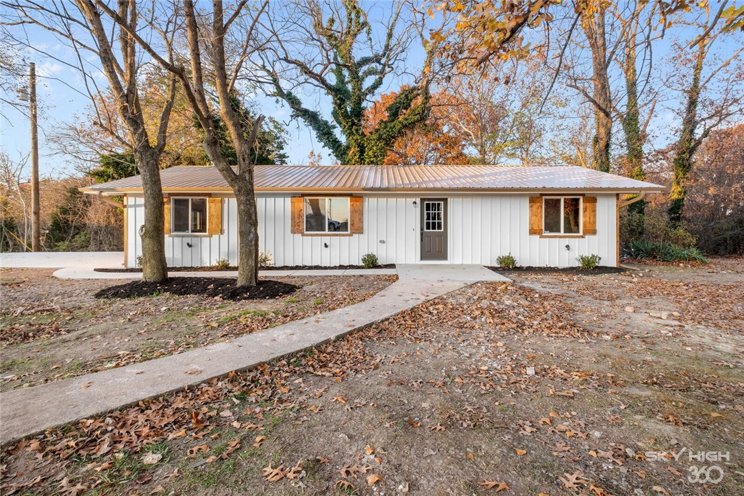 One of the more rare opportunities in NWA, 2+ acres in Rogers, AND a completely renovated from the studs up home for less than $200,000. The finishes in this country-feeling home have an eye-catching wow factor. The kitchen sports quartz countertops, and open plan, brand new cabinets, whirlpool appliances, and more. The kitchen leads to an open-floor plan central living area with beautiful south facing windows and a high-ceiling. Exposed rafters in the living area are painted to perfection. The high-grade vinyl flooring and stained trim on all doorways adds a distinct farm house finish. The outside is painted a bright white, and new windows and doors add to the updated feel. Freshly laid concrete will greet you in the driveway, and your commute into Rogers will be less than 10 minutes! Start your morning on the brand new back deck, and check out the hardwood-filled yard that compliments the home. First Showing Date - 10/30