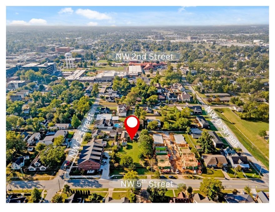 Unlock incredible potential on a prime .59-acre lot in the heart of downtown Bentonville—ideal for building, rental income, or full redevelopment. Dual access from 5th Street and rear alley adds flexibility. Just steps from the Bentonville Square, Crystal Bridges, Razorback Greenway, public schools, and MTB trails. The existing 1BR/1BA, 1,675 sqft Craftsman-style cottage, built in 2010, features light-filled living spaces with concrete floors, wood flooring in kitchen/bed/hall, and tile in bath. Add a stairway to expand into the unfinished upper level. Detached garage, she-shed, oversized 2-car carport/ pavilion, hot tub, above-ground pool, and garden areas all within a fully fenced yard. Live, rent, expand, or redevelop—this rare property offers unmatched flexibility in an unbeatable location.