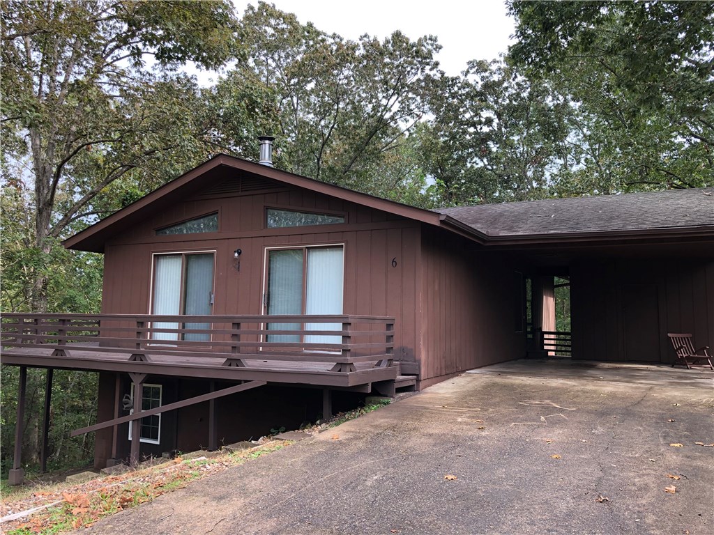 Cozy 2 bedroom 2 full bath home in Bella Vista. Located at end of cul-de-sac, very private. Wood floors throughout, large family rooms with wood burning stove, all appliances, breakfast nook opens to huge 2nd level wrap around porch, kitchen has plenty of countertop space and cabinets, spacious bedrooms, large closets. Looks like a resort property located in the hardwoods of Bella Vista. 2 car capacity carport, wonderful neighbors, minutes from everything.