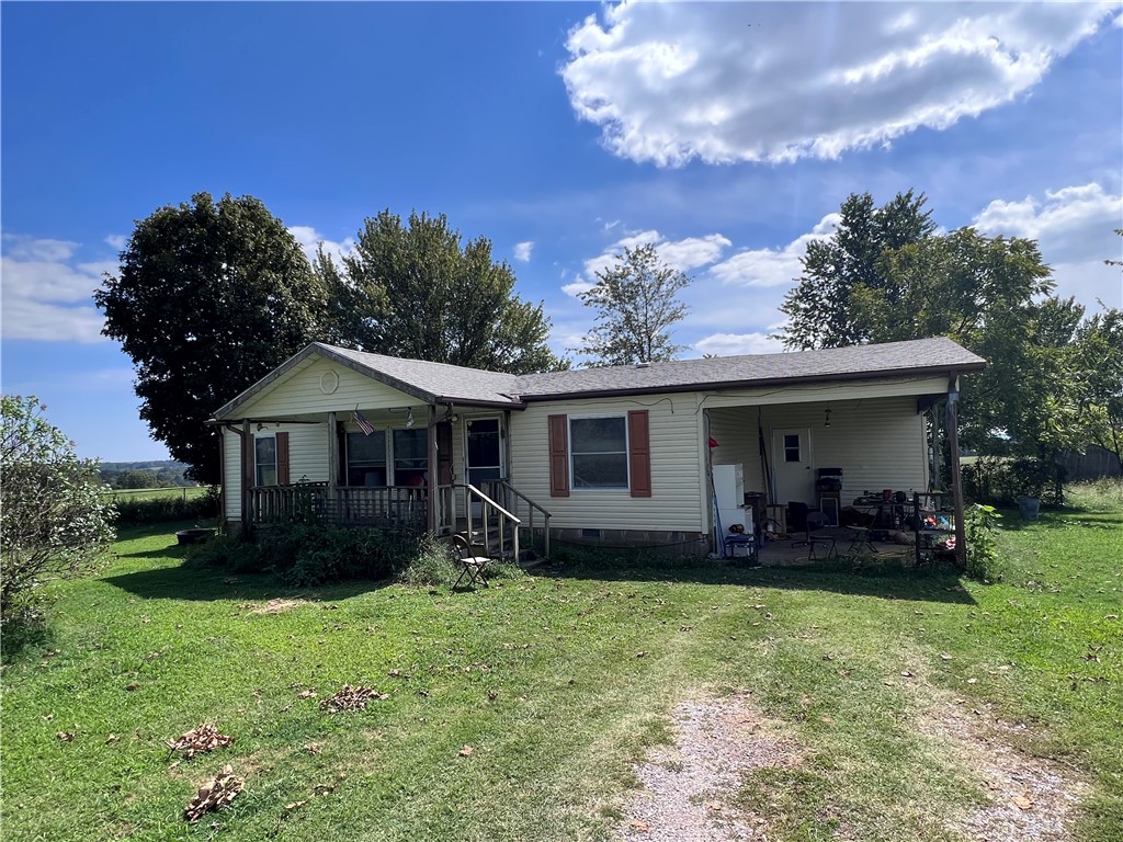 Beautiful 5.36+/- acres off Clifty highway/highway 12. Great location with lots of potential and gorgeous country views! Property has 2 wells, 2 septic tanks, rural water and electric. New breaker box in house as well as setup on the electric pole outside. Roof is only 1.5 years old. Yard contains 4 large silver maple trees and one large lilac bush. Land behind house grows thick mixed grass hay. Two storage buildings and large underground cellar on property. Just 1/2 mile to convenience store and Dollar General.
House is a manufactured home but is on a permanent block foundation.