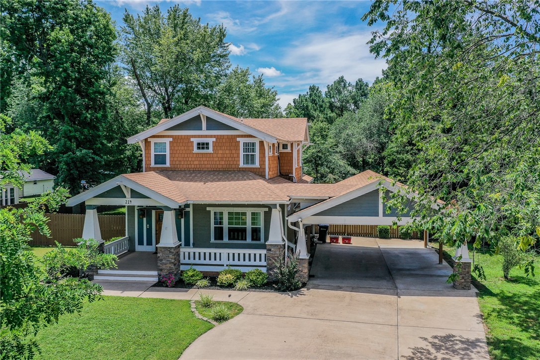Step into timeless charm with this stunning 2-story Craftsman-style home, designed with authentic details of a classic Airplane Bungalow, a 1920s favorite. Thoughtfully updated for modern comfort, you’ll love the exposed rafter tails, knee braces, and broad front and back porches with stone piers and heavy beam columns. The main level offers a spacious living area with a cozy gas fireplace, built-in shelving, and stained-glass accents. The kitchen features soapstone countertops, a large walk-in pantry, formal dining, and a breakfast nook perfect for casual meals. A half bath and utility room complete the main floor. Upstairs includes the primary suite with private bath and walk-in closet, plus two additional bedrooms and a full bath. Sitting on nearly half an acre, the outdoor space is exceptional—enjoy a covered 24x16 back deck, fire pit area, and a 12x12 outbuilding with loft. Plenty of space to add a pool, garden, or other backyard features on almost 1/2ac lot—your oasis awaits!
