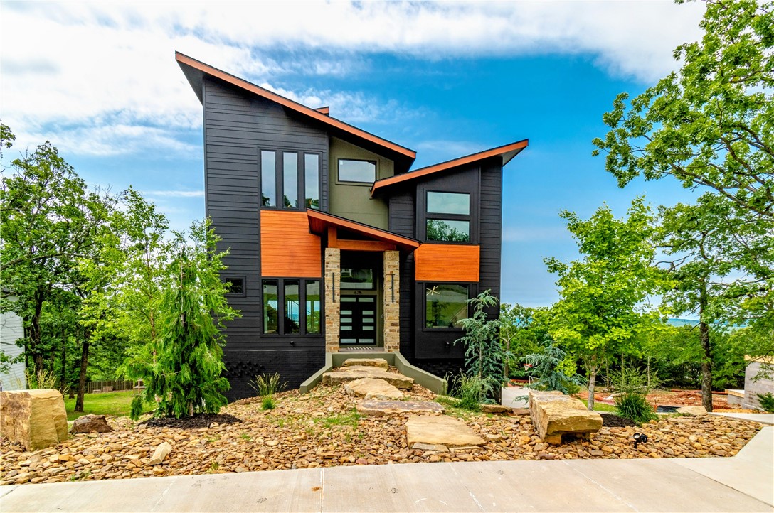 Welcome to this stunning custom-built home on a spacious half-acre lot in the highly sought-after Hyland Park subdivision. Designed for both comfort and style, this one-of-a-kind property offers panoramic views of Fayetteville through expansive picture windows and from a rooftop balcony wired for a hot tub and heaters. Inside, enjoy a custom waterfall island with quartz countertops, marble-look tile, luxury vinyl plank flooring, and double ovens. Thoughtful upgrades include solar panels (covering most of the electric bill), Sonos surround sound, whole-home water filtration, EV charger, tankless water heater, laundry chute, and customizable exterior lighting. The drive-through garage and floating staircase add even more appeal, along with a 500 sq ft unfinished basement. With 3 bedrooms, 3.5 baths, an office, and a large media/game room, this home blends modern design with everyday convenience. A rare opportunity you won’t want to miss!
