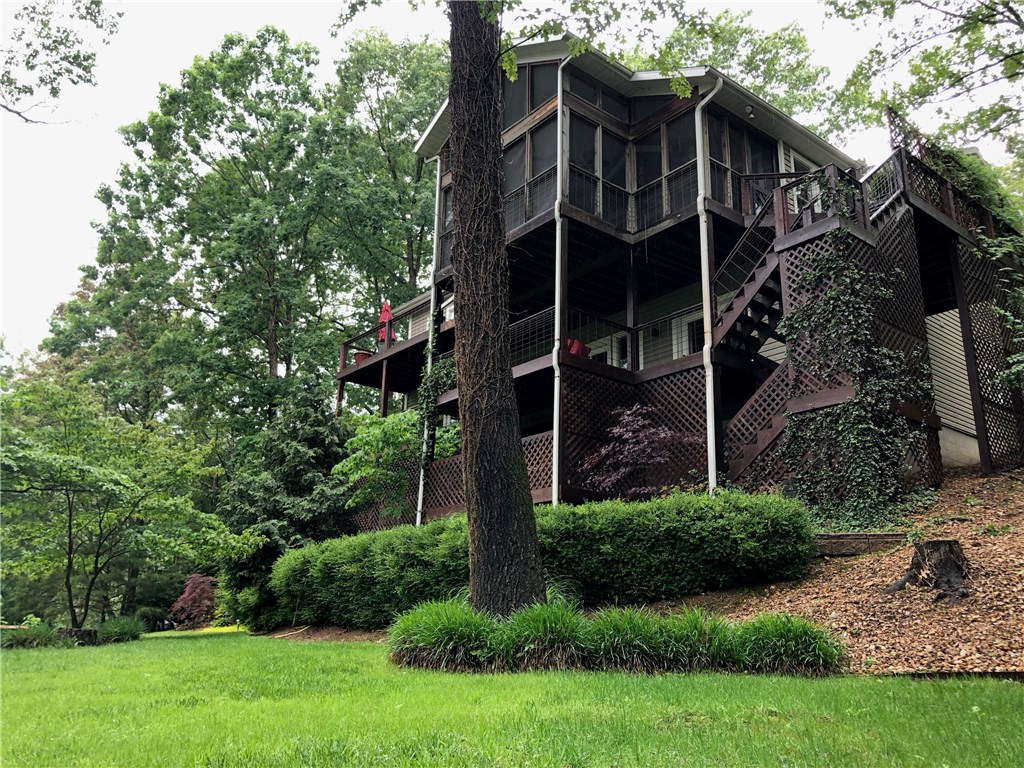 Priced to sell. Stunning Lakefront home!! This gorgeous home is move in ready.New roof and air conditioner. All the updates as already been done! All you have to do is move in and spend your summer relaxing on the deck, or on the over sized boat dock. The dock also has a covered slip and lift, and a storage room for all those lake toys.The boat is also for sale. Extra lg dock with electric and fresh water. Perfect for entertaining. While inside the house you feel like you are on vacation! The open floor plan and tons of windows give the feeling of being in a tree house. The master has a newly remodeled spa like bathroom and is plumbed for a bathtub.The downstairs is perfect for a teen space. It is a split floor plan with two master suites with a living area in the middle. Each room has doors that walk out to the deck. The lawn has front and back irrigation that is fed from the lake. Beautiful landscaping. You wont find another home like this one on the lake.
