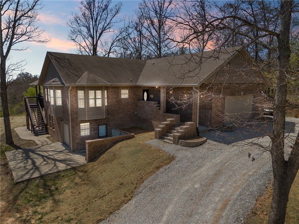 $10k in seller concessions offered! This unique property offers a rustic cabin feel with modern amenities, making it a perfect blend of comfort and charm. With 3 bedrooms, 3 bathrooms, an office and large bonus room down stairs, this house is ideal for anyone looking for space and tranquility. The walkout basement opens up to expansive outdoor space, inviting you to enjoy quiet mornings or entertain guests amidst nature's backdrop. Not part of the POA, this home ensures privacy while keeping you close to community features. Just a stone's throw away, you'll find Cooper Elementary, Interstate 49, and nearby Mercy Emergency Department offers peace of mind, knowing healthcare is readily accessible and the Trailhead Blowing Springs Back 40 offers outdoor enthusiasts a chance to explore and stay active. This home is more than a place to live; it's a lifestyle waiting to be embraced. Home has been updated along with a new filtration system for the well water, AC is 2 yrs old!