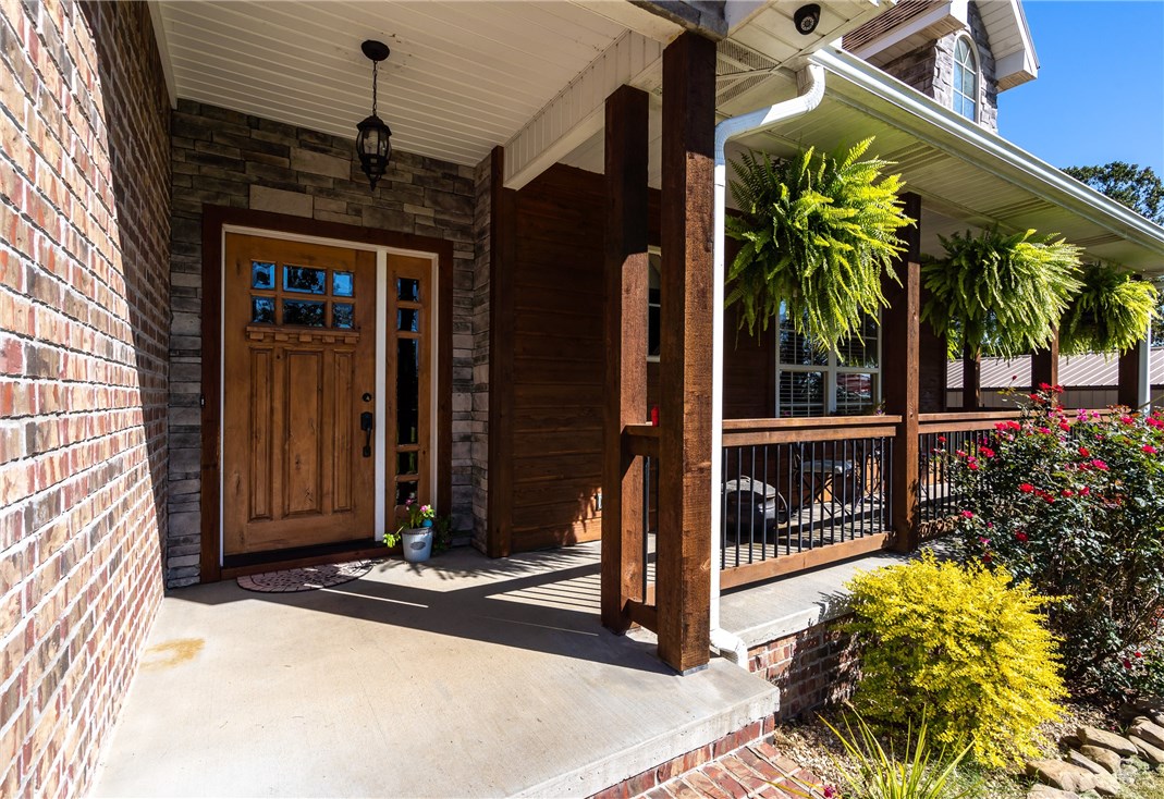 Enjoy the beauty of country living in this 4 BR 2 BA home sitting on .91 acres on a quiet paved street just 16 mi. from Bentonville & 17 mil. from Siloam Springs & 10 mi. from Gentry. Large workshop w/ double doors w/18' x 12" bonus/game room with wet bar and heat and air. In ground storm shelter for those occasional weather alerts. This gorgeous home has vaulted ceilings and a split floor plan with master suite, formal dining room and breakfast nook. This home has high ceilings with large open areas and indirect lighting throughout with gas fireplace in living room and wood and tile floors throughout. New appliances in 2018 include convection oven and programmable, convection microwave. And if this is not enough, there is a recently added decked-in above ground swimming pool just beyond the covered patio for your enjoyment during our long, hot Arkansas summers. You will enjoy seeing the seasons change in this lovely setting. Country setting minutes from shopping and business areas. This is must see property!